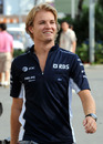 Nico Rosberg smiles as he walks along the paddock