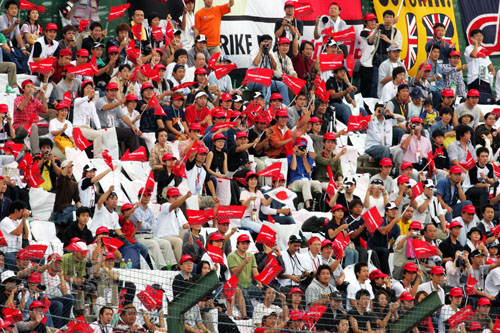 Japanese fans cheer on the drivers at Suzuka