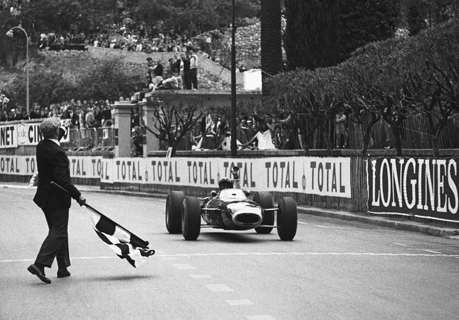 Graham Hill in his BRM taking the chequered flag