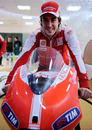 Fernando Alonso poses for photos on a MotoGP bike