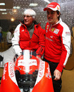 Bernie Ecclestone and Fernando Alonso pose with a MotoGP bike