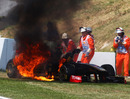 Nick Heidfeld jumps out of his Renault as it goes up in flames 