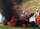 Nick Heidfeld leaps from his burning Renault