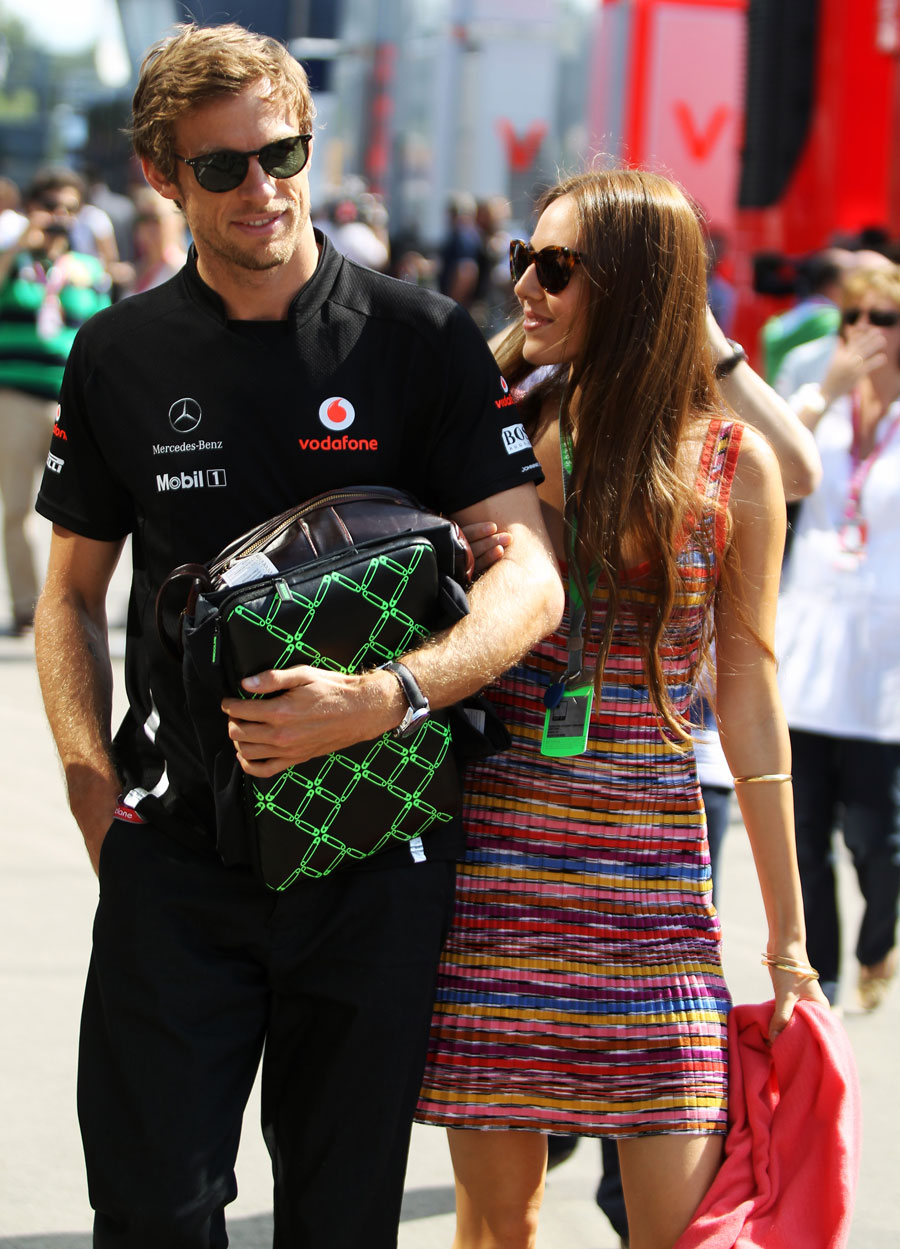 Jenson Button arrives in the paddock with girlfriend Jessica Michibata