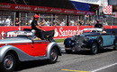 Lewis Hamilton and Jenson Button share a joke on the drivers' parade