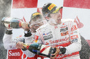 Lewis Hamilton and Jenson Button celebrate on the podium