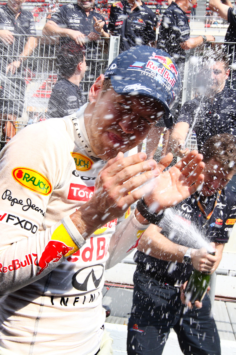 Sebastian Vettel is bathed in champagne after taking his fourth victory of the season