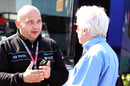 HRT team principal Colin Kolles talks to FIA technical delegate Charlie Whiting in the paddock before the race