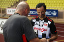Tonio Liuzzi signs an autograph during a charity football match in Monaco