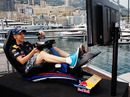 Sebastian Vettel gets some practice in on a computer game before taking to the track for real