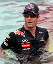 Mark Webber answers media questions from the cool of the Red Bull pool
