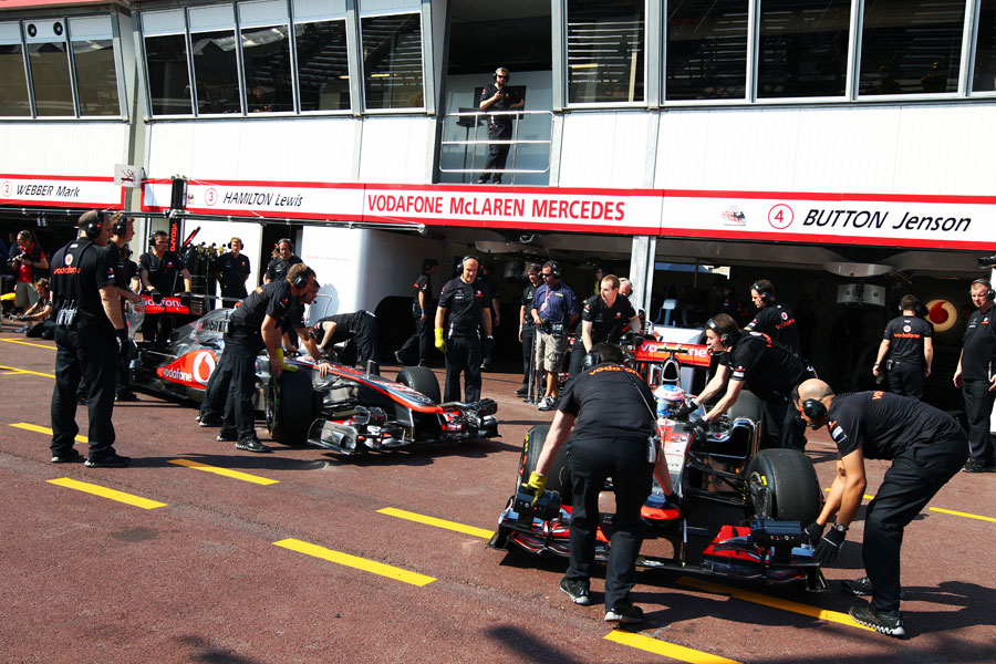 Jenson Button and Lewis Hamilton demonstrate how tight it is in the pit lane