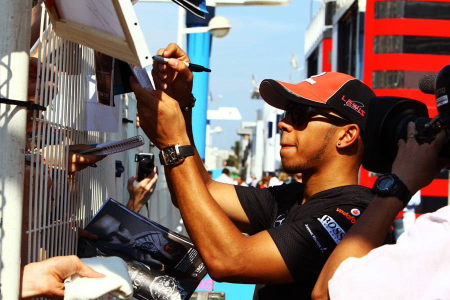 Lewis Hamilton signs autographs in Monaco