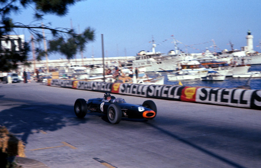 Graham Hill blasts past the harbour on his way to victory
