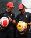 Jenson Button and Lewis Hamilton compare their special diamond-encrusted helmets