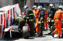 Medics and marshals tend to Sergio Perez's car