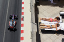 Lewis Hamilton passes a couple of sunbathers