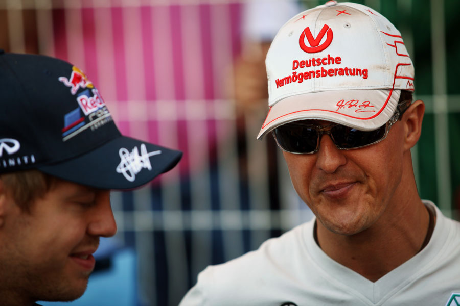 Sebastian Vettel and Michael Schumacher chat before the start of the race