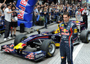 Sebastien Buemi poses for photographers beside Formula One machine of Red Bull in Japan 