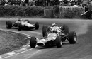 Graham Hill slides his BRM as he tries to hold off John Surtees and Jim Clark