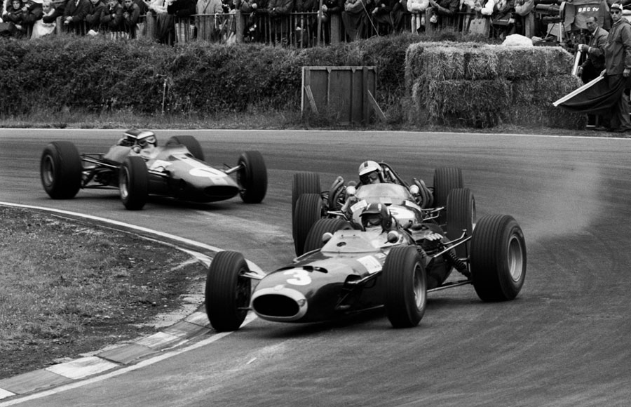 Graham Hill slides his BRM as he tries to hold off John Surtees and Jim Clark