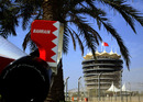 A model of a Formula 1 car is displayed in front of the Bahrain International Circuit tower