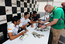 Narain Karthikeyan, Tonio Liuzzi and Mark Webber sign autographs for fans