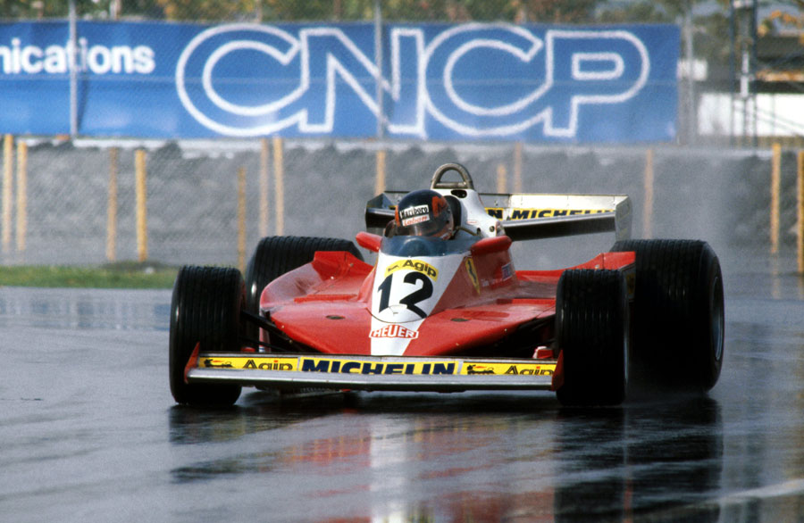 Gilles Villeneuve holds a slide in his Ferrari