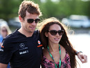 Jenson Button arrives in the paddock with girlfriend Jessica Michibata on Friday morning