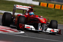 Fernando Alonso flings his Ferrari towards the apex
