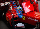 Fernando Alonso sits in his Ferrari ahead of practice