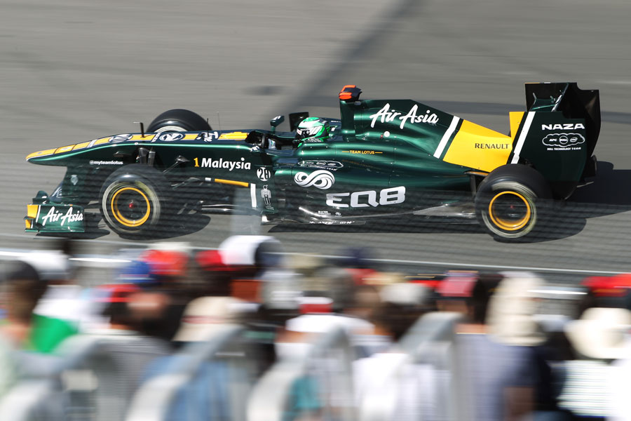 Heikki Kovalainen speeds past the grandstands