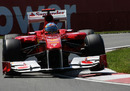 Fernando Alonso rides the kerbs in his Ferrari
