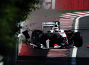 Kamui Kobayashi rebounds off the wall at the exit of turn four