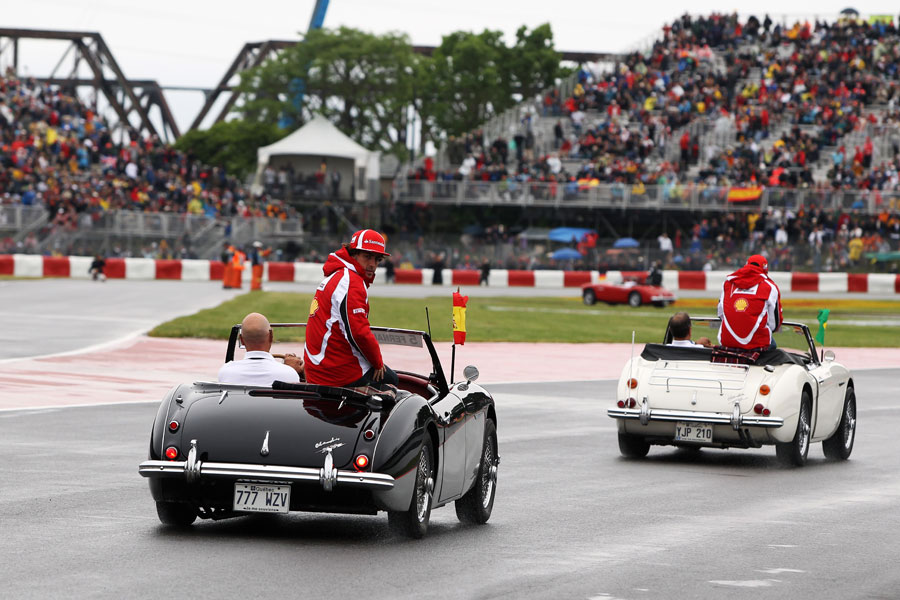 Fernando Alonso follows Felipe Massa on a wet drivers' parade