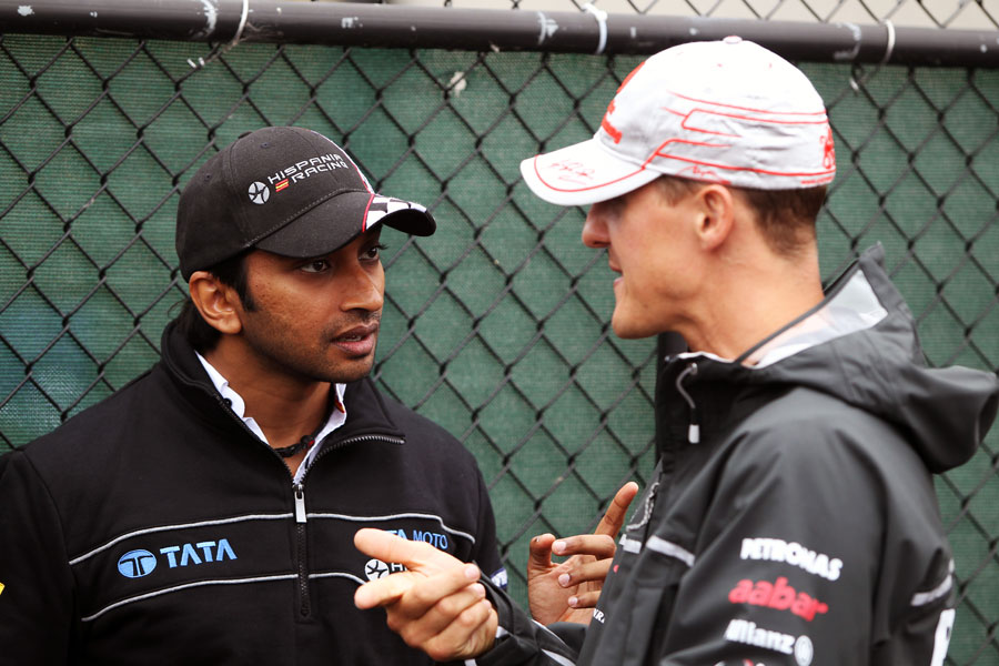 Narain Karthikeyan and Michael Schumacher chat ahead of the race