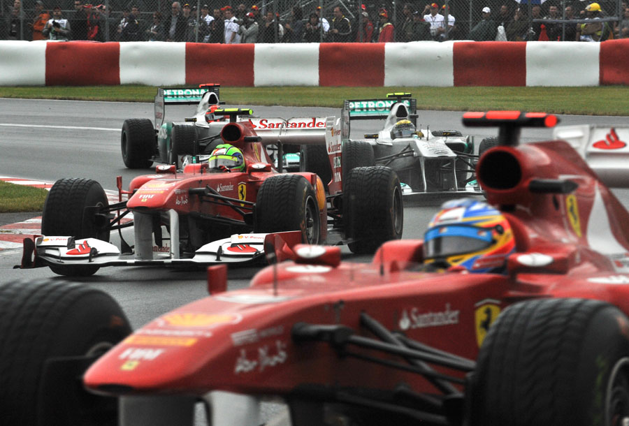 Fernando Alonso runs wide as Felipe Massa holds off the Mercedes