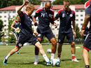 Sebastian Vettel tackles footballer Thierry Henry during a training session with the New York Red Bulls