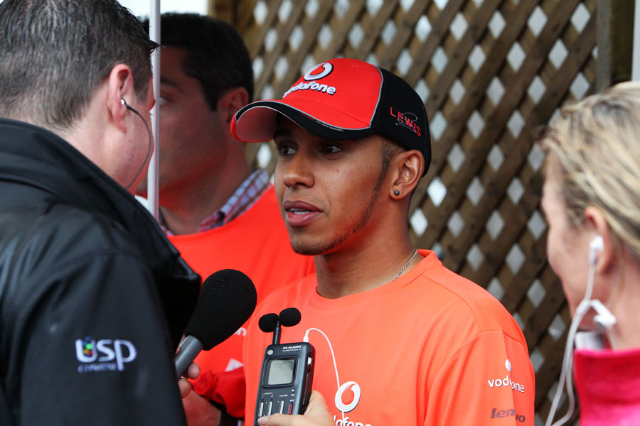 Lewis Hamilton talks to the media after Jenson Button's victory