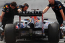 Sebastian Vettel is pushed back into the Red Bull garage
