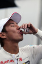 Kamui Kobayashi celebrates his seventh place with a tequila