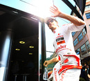 Jenson Button walks into the McLaren motorhome
