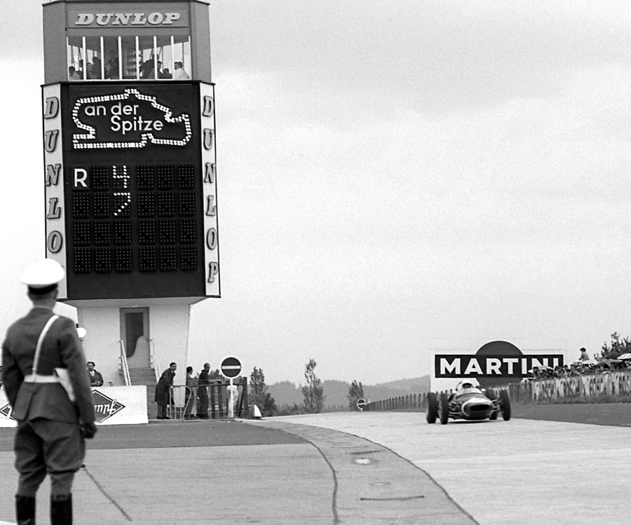 Stirling Moss on his way to victory ahead of the Ferraris