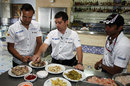 Narain Karthikeyan, Tonio Liuzzi and race engineer Antonio Cuquerella prepare to make paella