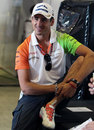 Adrian Sutil relaxes in the Force India garage
