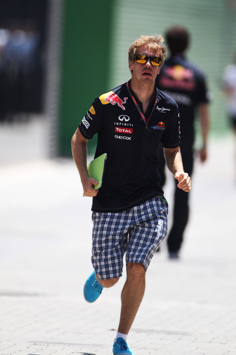 Sebastian Vettel runs through the paddock