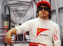 Fernando Alonso relaxes at the back of the garage