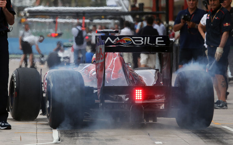 Daniel Ricciardo lights up his tyres as he leaves his pit box