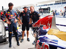 Mark Webber inspects the Red Bull engine cover in the pit lane