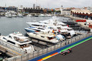 Lewis Hamilton passes boats in the harbour